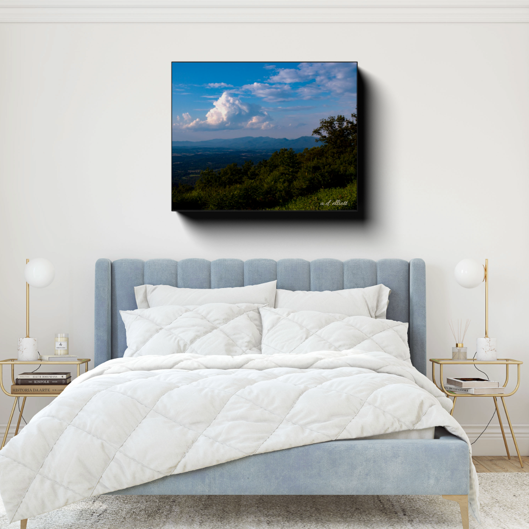 Farms From the Blue Ridge Parkway canvas photograph displayed above a light blue bed in a bright bedroom with gold-accented side tables.
