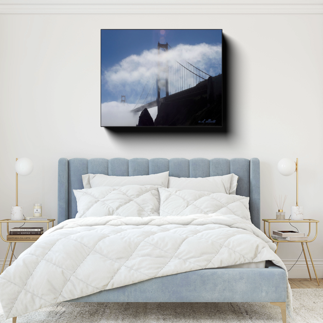 Golden Gate Bridge canvas photograph displayed above a light blue bed in a bright bedroom with gold-accented side tables.