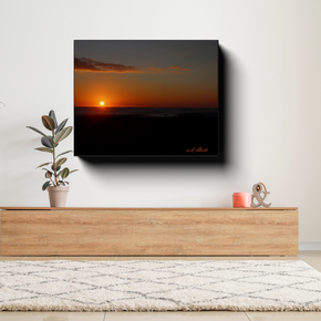 Gallery-wrapped canvas featuring an October sunrise over Virginia Beach displayed above a wooden console table in a bright contemporary living room.