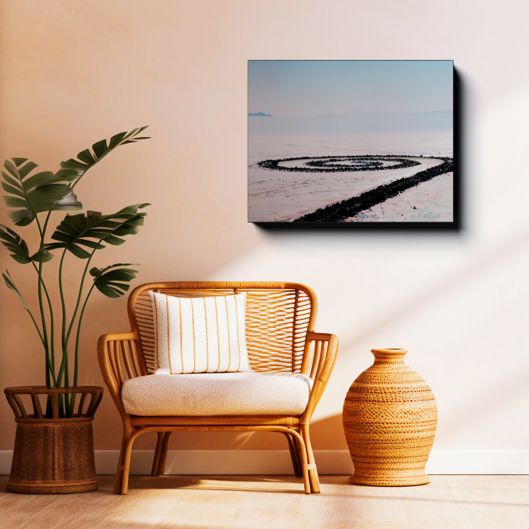 Gallery-wrapped canvas featuring Spiral Jetty displayed above a wicker chair in a warm, modern living room setting.