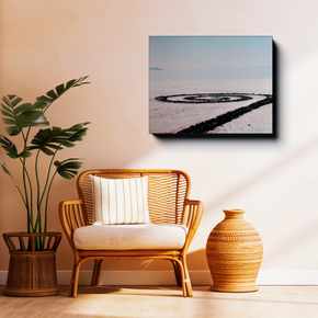 Gallery-wrapped canvas featuring Spiral Jetty displayed above a wicker chair in a warm, modern living room setting.