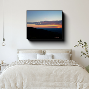 Sunset Along the Blue Ridge Parkway canvas print displayed above a neatly made bed in a bright, minimal bedroom.