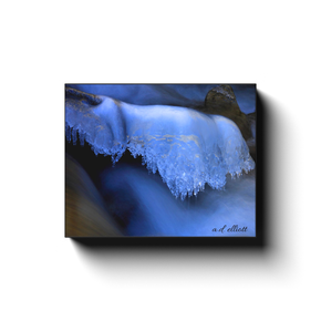 Gallery-wrapped canvas print featuring smooth blue water flowing beneath delicate winter ice.