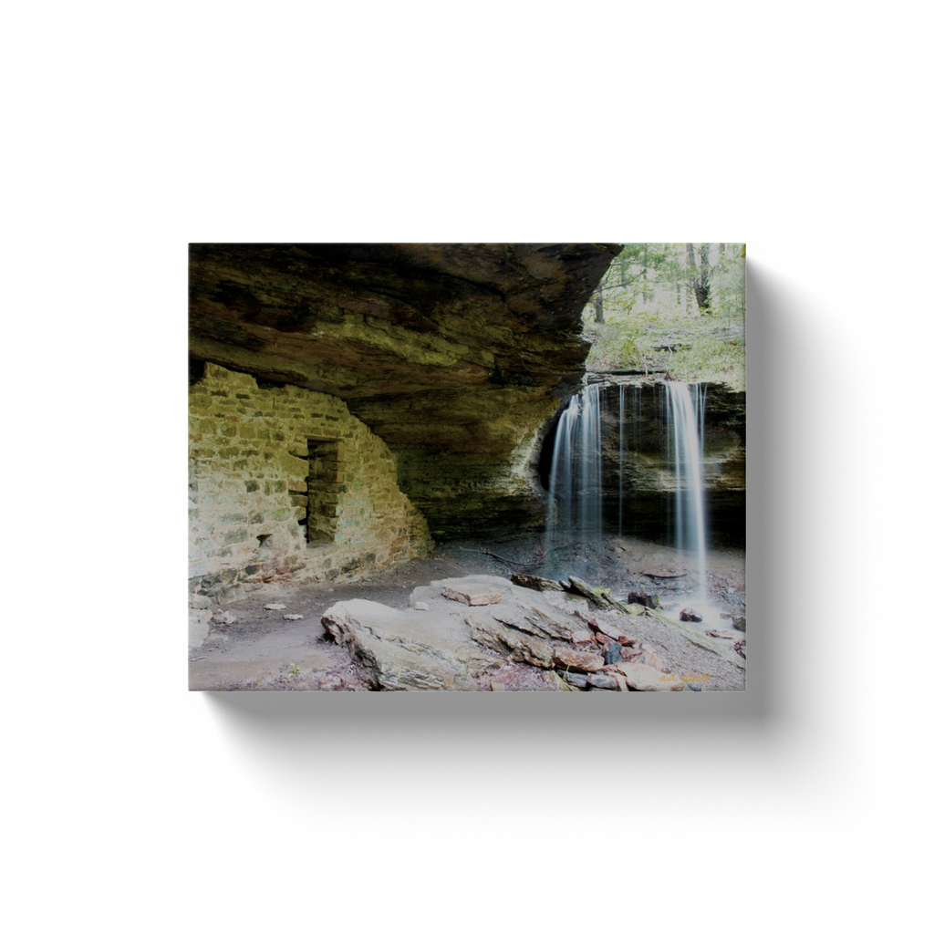 A long exposure photograph of the waterfall called Moonshiner's Falls near Winslow Arkansas, taken by the photographer a.d. elliott  Printed on high quality, artist-grade stock and folded around a lightweight frame to give them a gorgeous, gallery-ready appearance. With acid-free ink that will last without fading or chipping, Features a scratch-resistant UV coating. Wipes clean easily with a damp cloth or to remove dust, vacuum gently using a soft brush attachment.