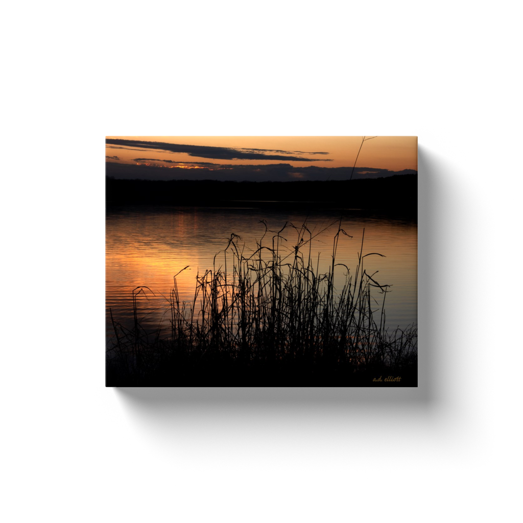 A landscape photograph of a sunset over Lake Loch Lomond in Bella Vista Arkansas. Taken by the Arkansas photographer a.d. elliott. #TaketheBackRoads  Printed on high-quality, artist-grade stock and folded around a lightweight frame to give them a gorgeous, gallery-ready appearance. With acid-free ink that will last without fading or chipping, Features a scratch-resistant UV coating. Wipes clean easily with a damp cloth or to remove dust, vacuum gently using a soft brush attachment.