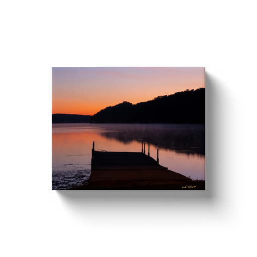 A landscape photograph of Tiree Dock on Loch Lomond, Bella Vista Arkansas at dawn.  Printed on high quality, artist-grade stock and folded around a lightweight frame to give them a gorgeous, gallery-ready appearance. With acid-free ink that will last without fading or chipping, Features a scratch-resistant UV coating. Wipes clean easily with a damp cloth or to remove dust, vacuum gently using a soft brush attachment.