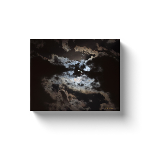 A photograph of the moon obscured behind clouds taken by the Arkansas photographer a.d. elliott.  Printed on high quality, artist-grade stock and folded around a lightweight frame to give them a gorgeous, gallery-ready appearance. With acid-free ink that will last without fading or chipping, Features a scratch-resistant UV coating. Wipes clean easily with a damp cloth or to remove dust, vacuum gently using a soft brush attachment.