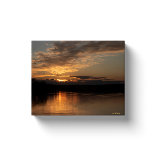 A landscape photograph of a sunset over Lake Loch Lomond in Bella Vista Arkansas. Taken by the Arkansas photographer a.d. elliott.  Printed on high quality, artist-grade stock and folded around a lightweight frame to give them a gorgeous, gallery-ready appearance. With acid-free ink that will last without fading or chipping, Features a scratch-resistant UV coating. Wipes clean easily with a damp cloth or to remove dust, vacuum gently using a soft brush attachment.
