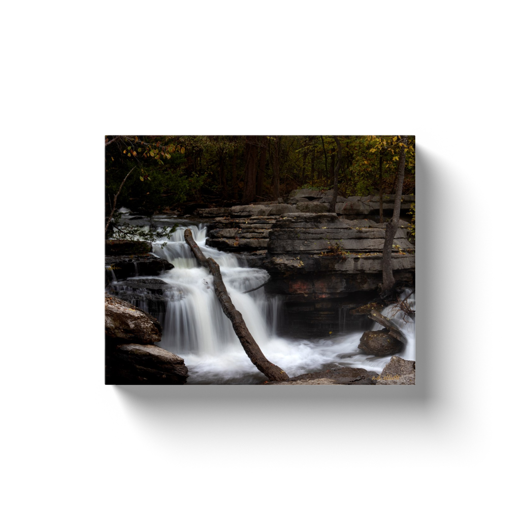 A long-exposure photograph of Lake Ann Falls, Bella Vista Arkansas.  Printed on high quality, artist grade stock and folded around a lightweight frame to give them a gorgeous, gallery ready appearance. With acid free ink that will last without fading or chipping, Features a scratch-resistant UV coating. Wipes clean easily with a damp cloth or to remove dust, vacuum gently using a soft brush attachment.