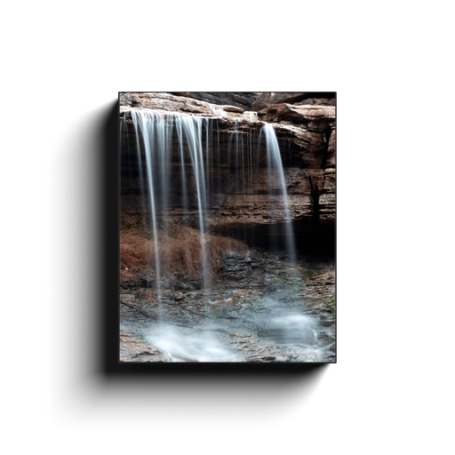A long exposure photo of Pinion Falls, located in Bella Vista Arkansas. Taken by the photographer a.d. elliott - Take the Back Roads #TaketheBackRoads  Printed on high quality, artist-grade stock and folded around a lightweight frame to give them a gorgeous, gallery-ready appearance. With acid-free ink that will last without fading or chipping, Features a scratch-resistant UV coating. Wipes clean easily with a damp cloth or to remove dust, vacuum gently using a soft brush attachment.